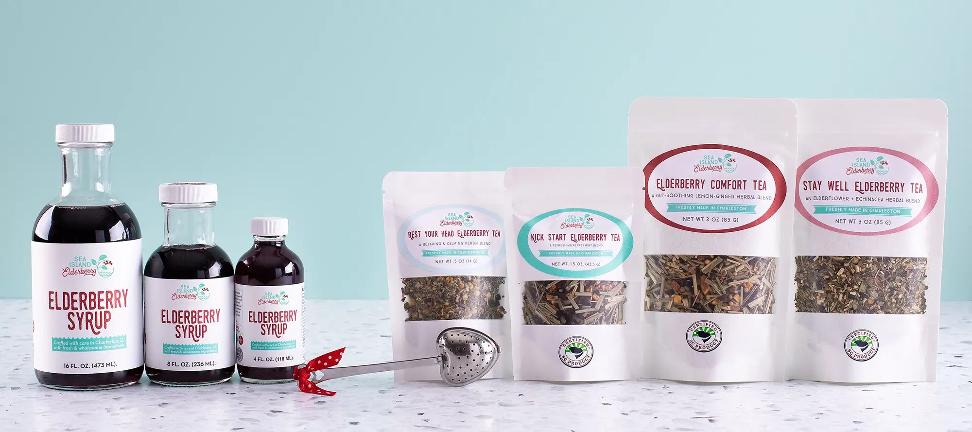 Collection of elderberry products including syrup bottles and tea packages on a light blue background