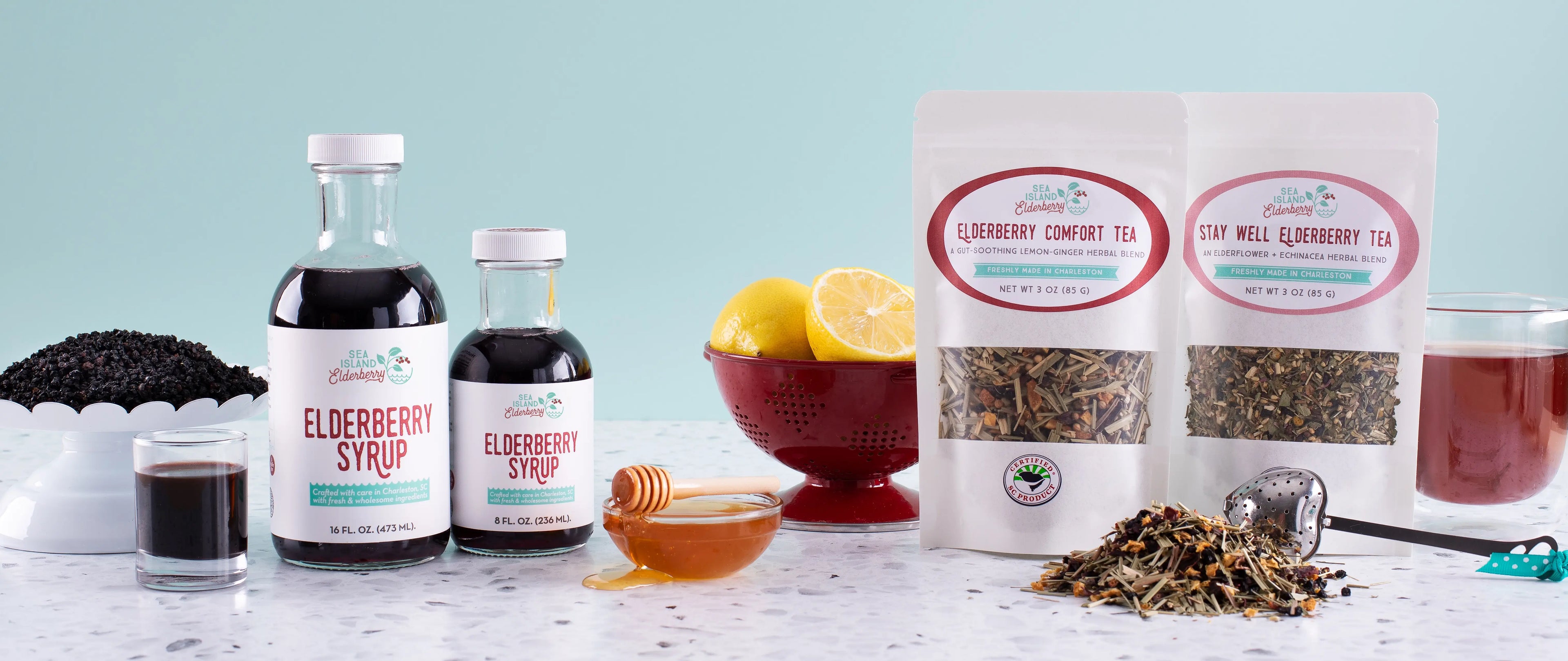 An assortment of Sea Island Organics elderberry products and ingredients on a counter.